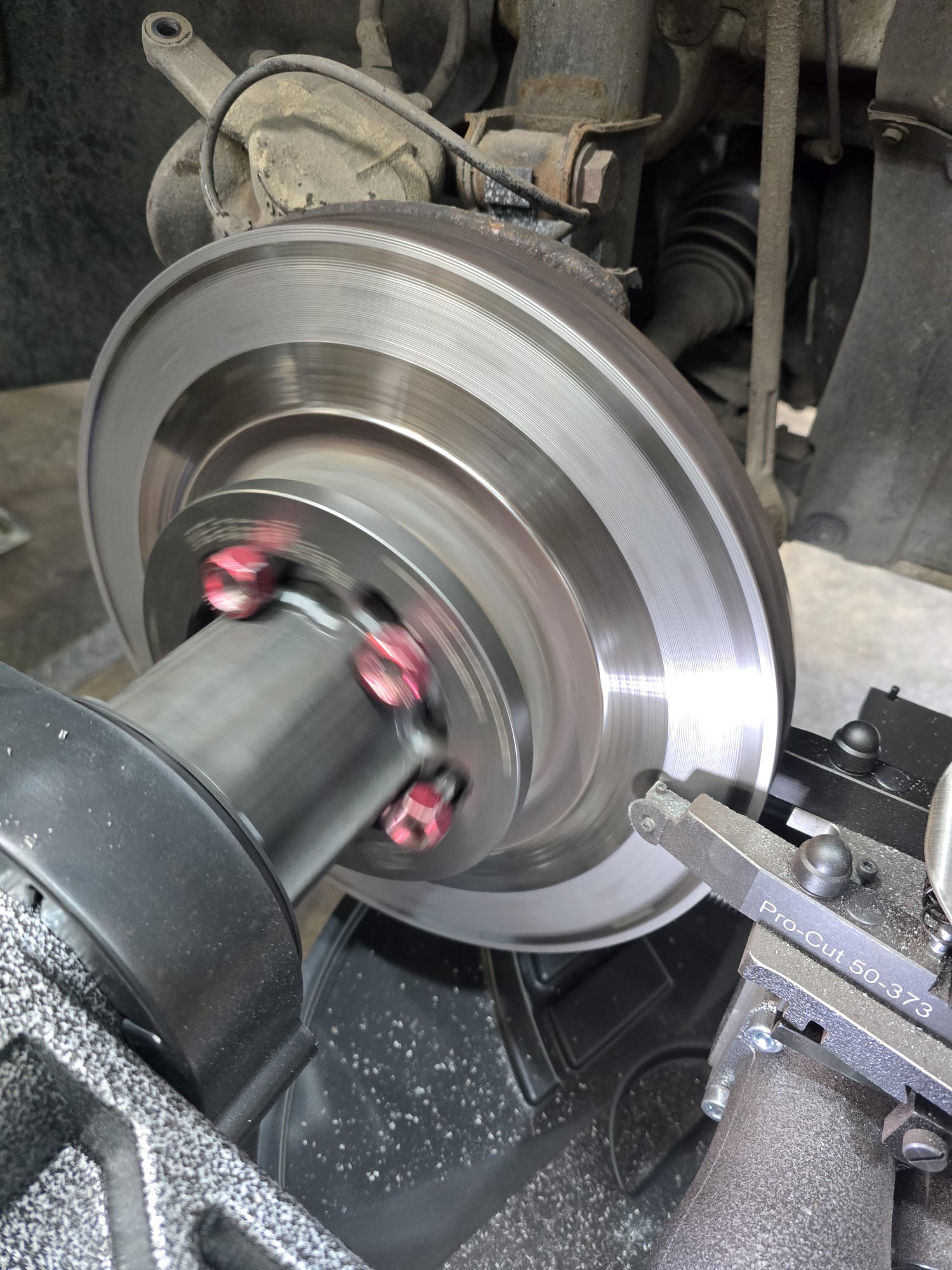Close-up of a brake disc being resurfaced on a lathe