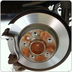 Freshly skimmed silver brake disc mounted on a vehicle hub