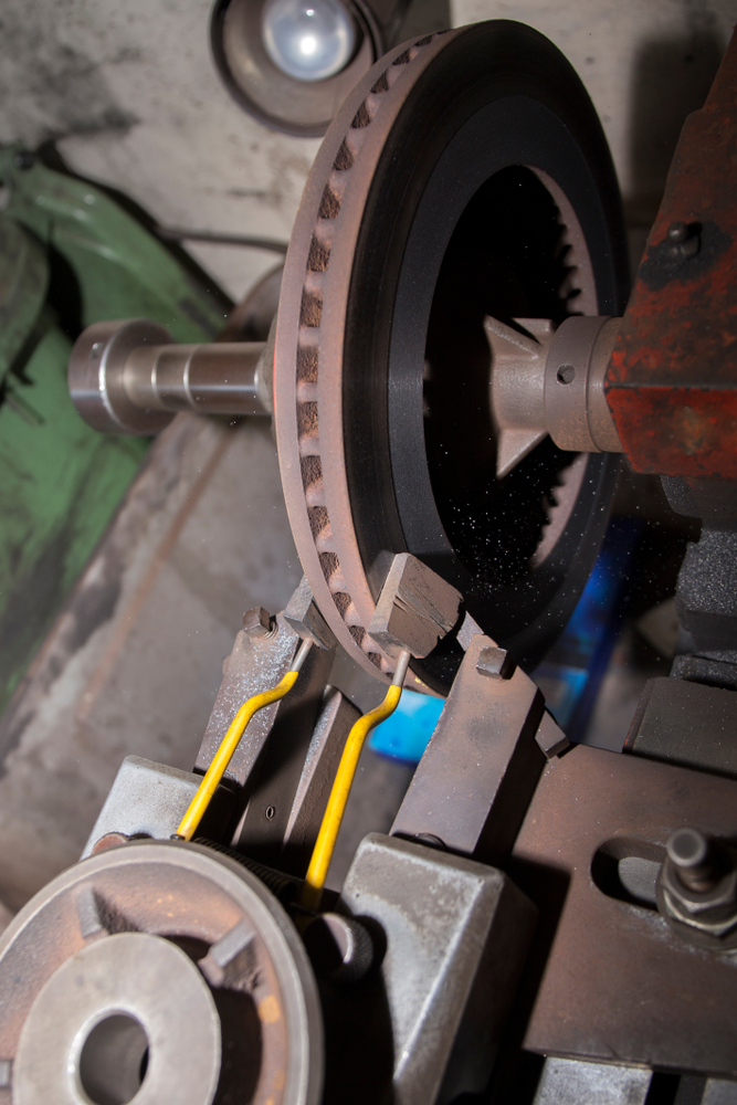 Side view of a ventilated brake disc and machining equipment